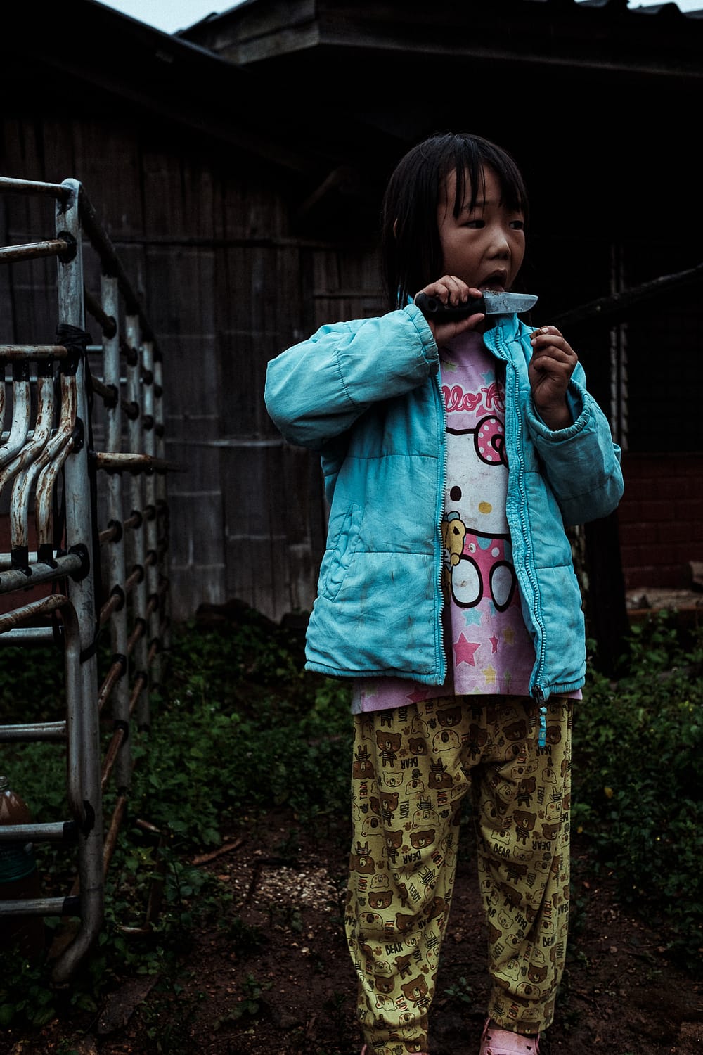 Kid playing with a knife in a village near Chiang Mai, thailand. November 2018