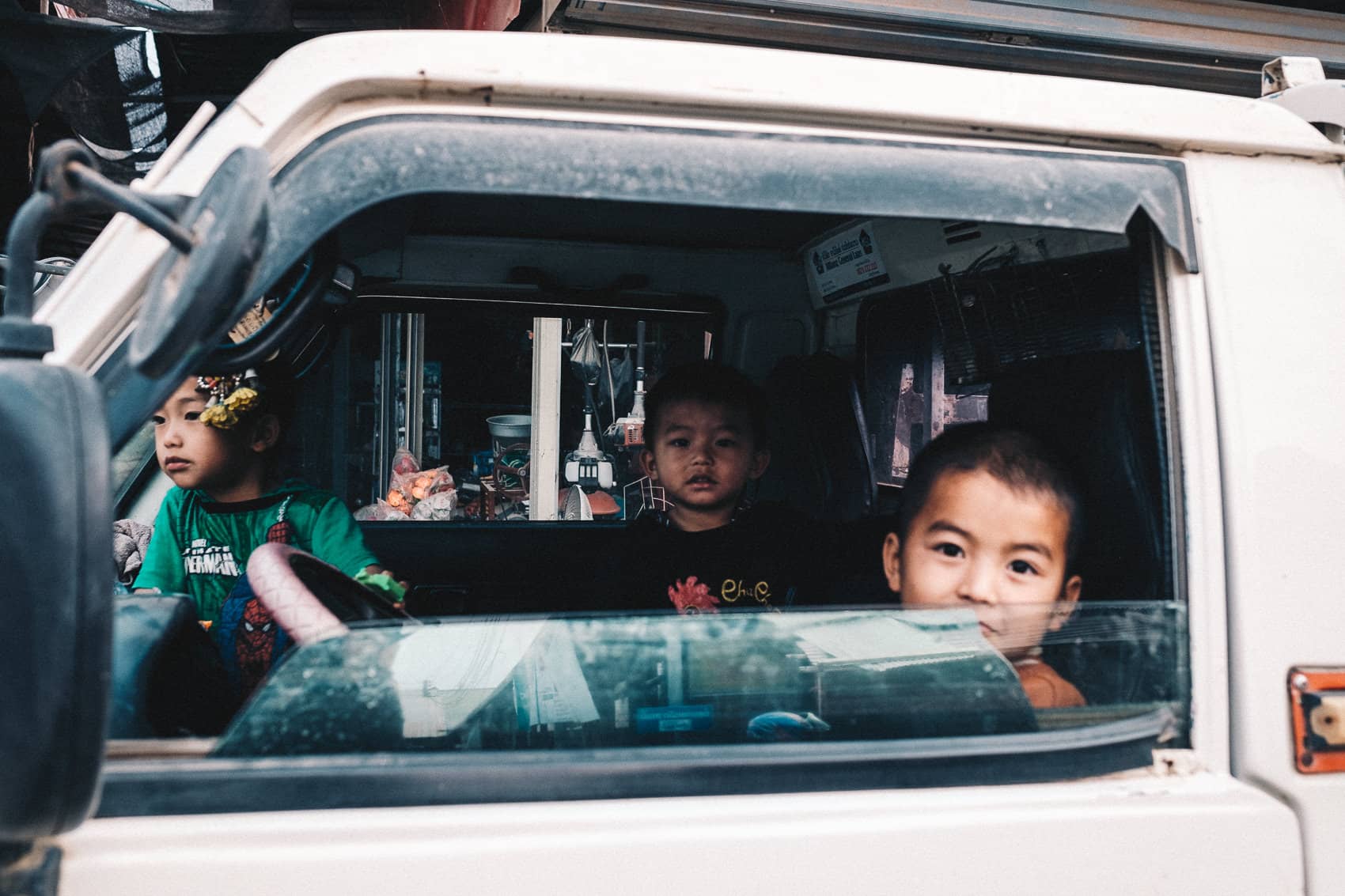 Laos Phonsavan 2019 10 Three Boys In the Car